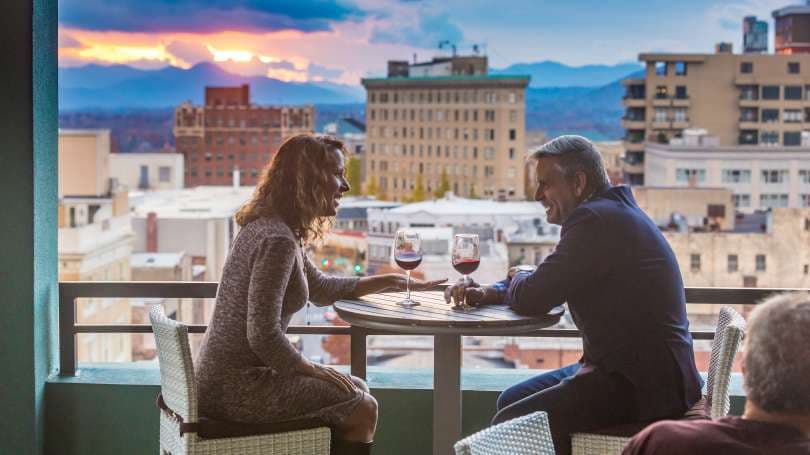 Rooftop bar with couple over Asheville 