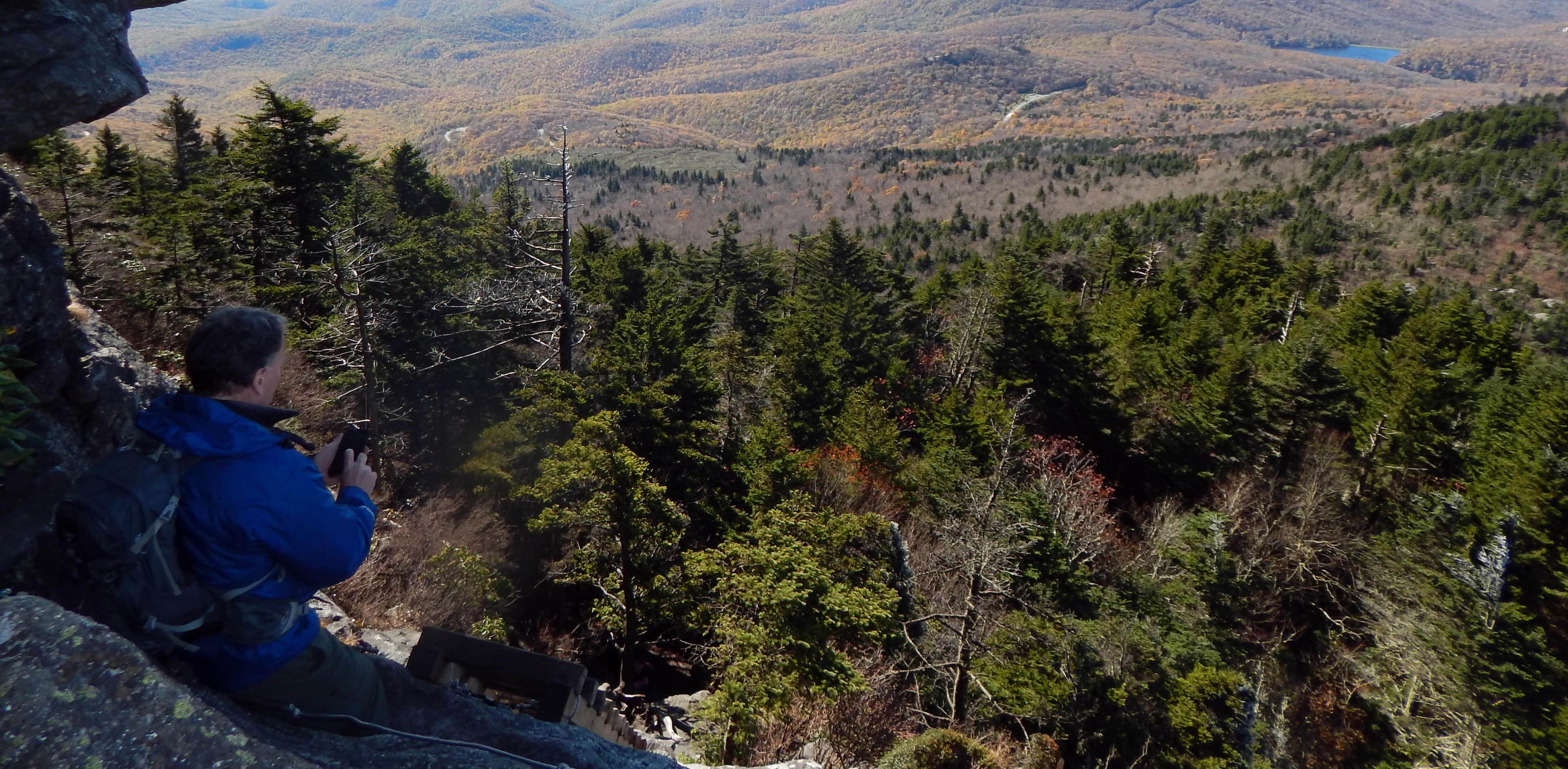 Man on Grandfather Trail sitting soaking in the views Asheville