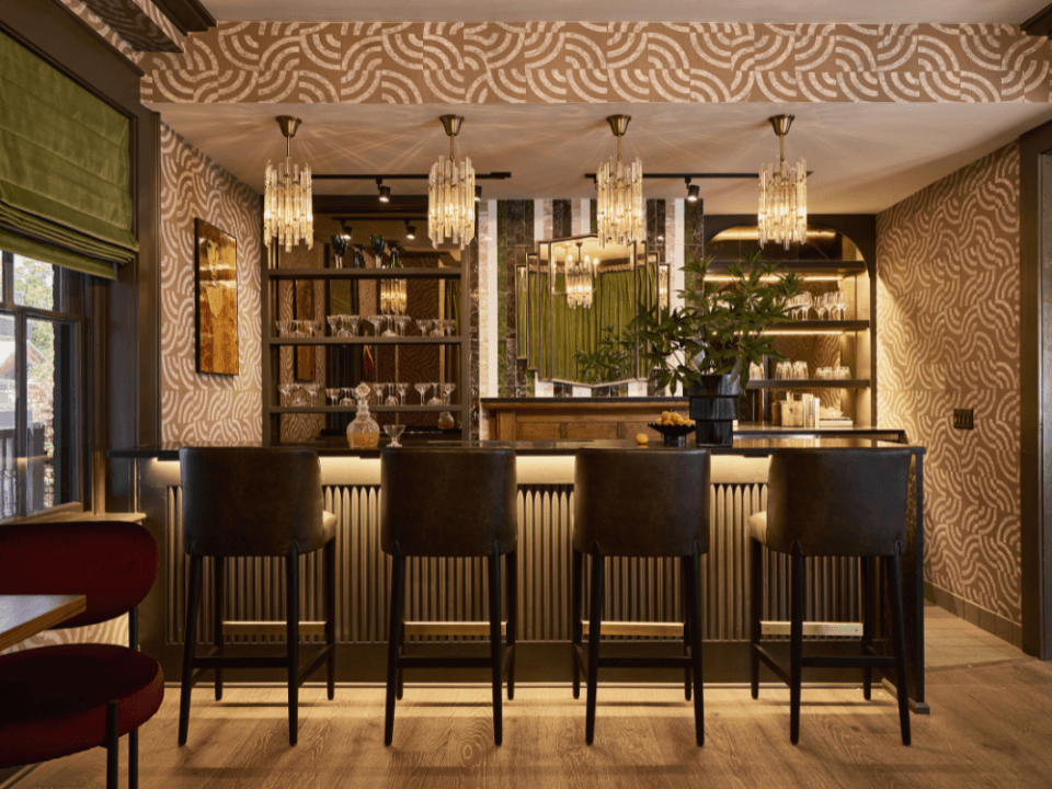four brown bar stools at a green and pink 1920s themed bar four brown bar stools at a green and pink 1920s themed bar